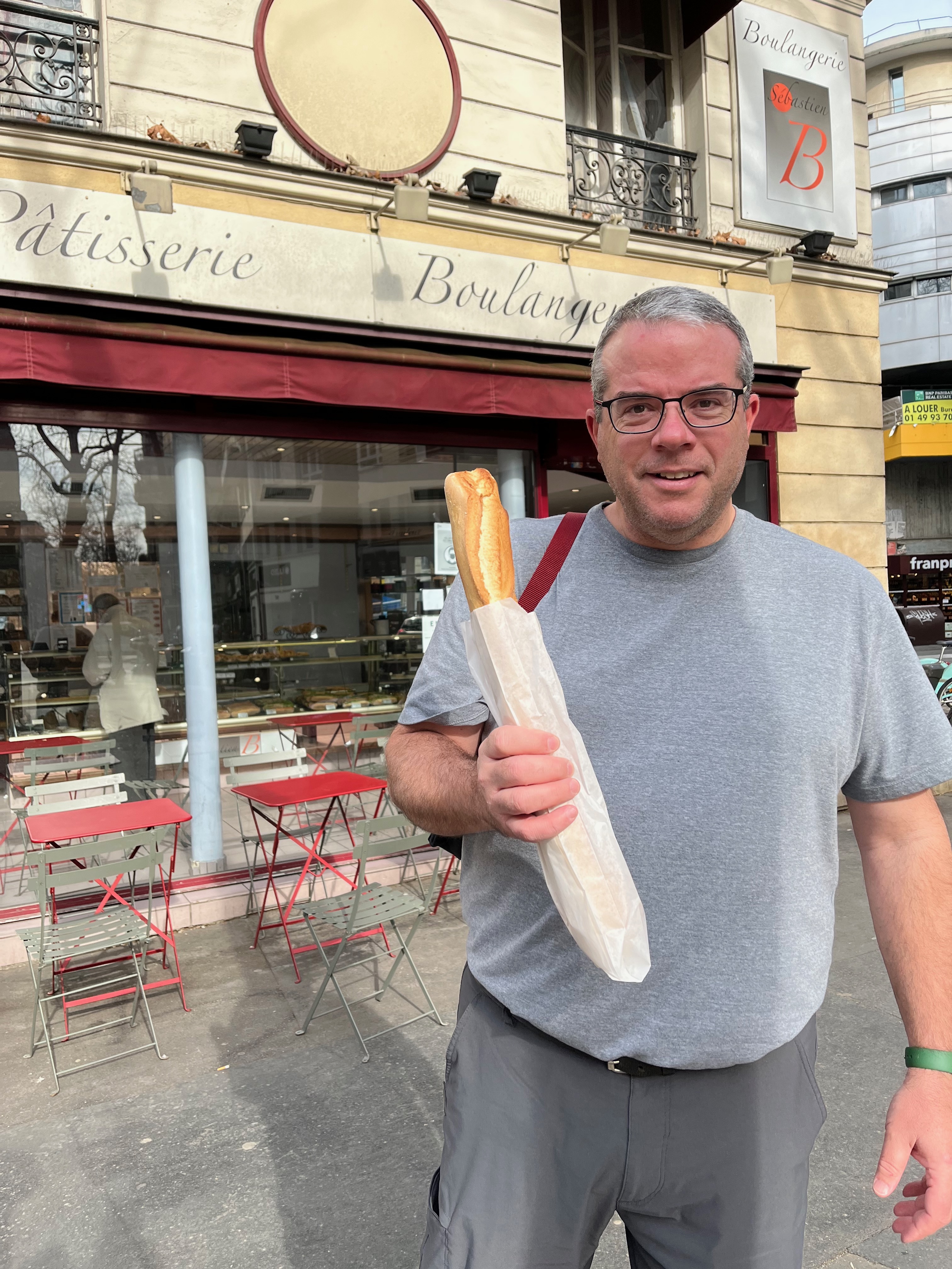 Chuck with a baguette at the boulangerie.